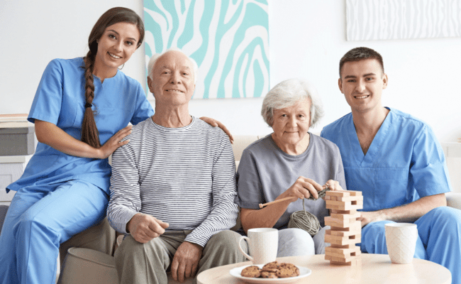 Staff and residents enjoying a game in a cozy common area