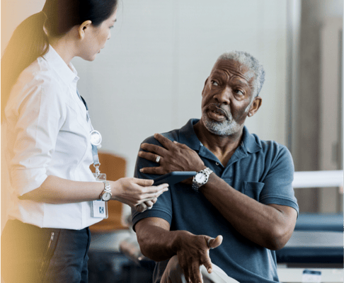 A staff member consulting with a male resident