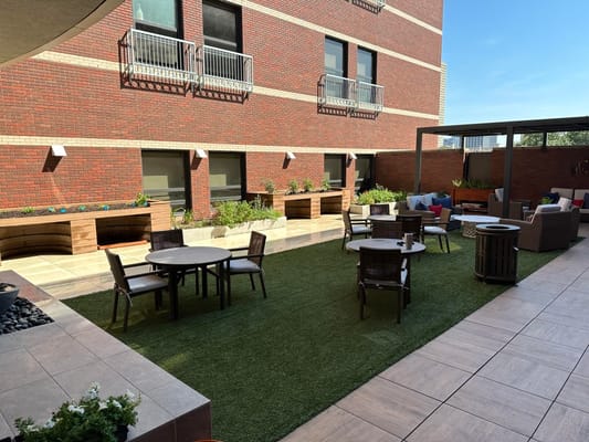 Outdoor courtyard with seating and greenery