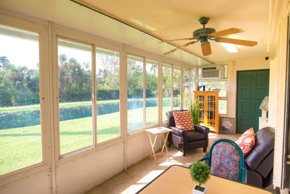 Bright sunroom with comfortable seating and view of garden