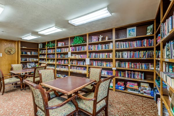 Cozy library space with bookshelves and tables