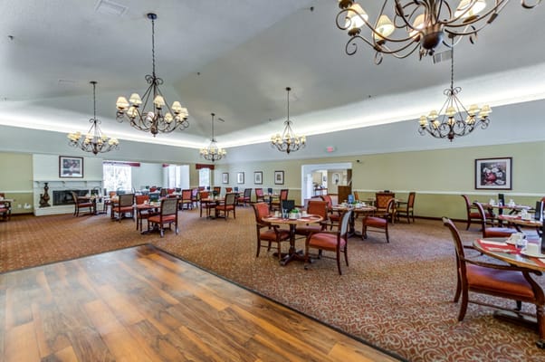 Spacious dining room with chandeliers and tables at Savant of Jurupa Valley.