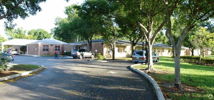 Exterior view of a senior care facility with trees