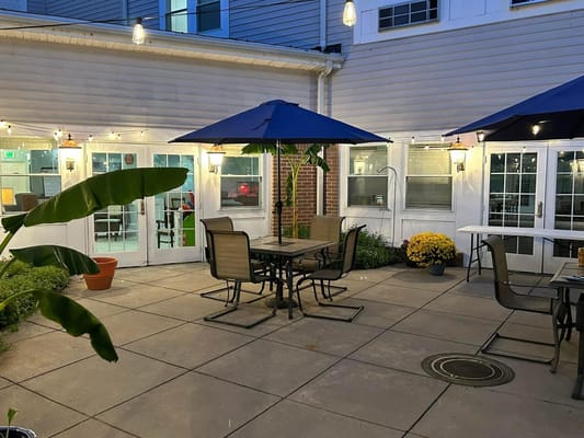 Quiet outdoor patio area with tables and umbrellas