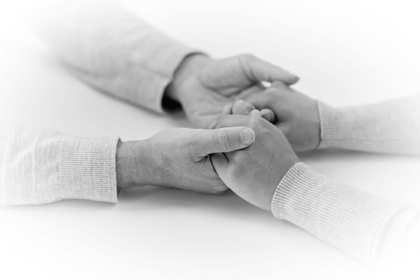Two hands holding each other in a supportive gesture