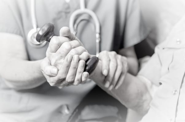 Medical staff assisting a resident with therapy.