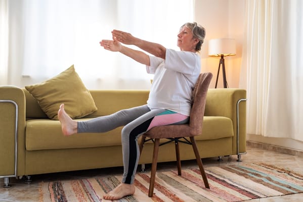 An older woman exercising in a living room
