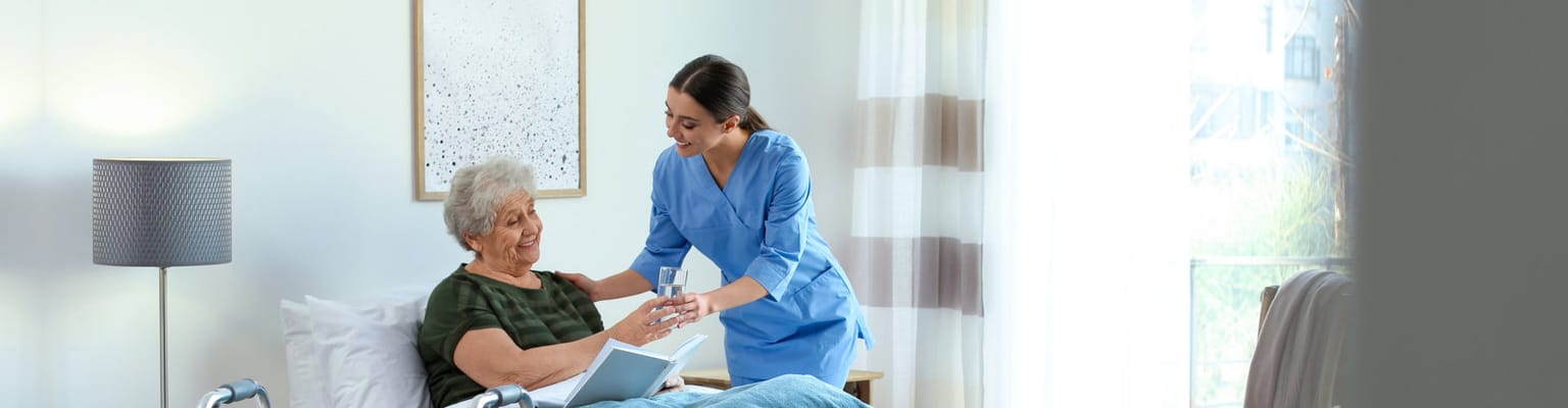 Caregiver assisting a resident in a cozy room