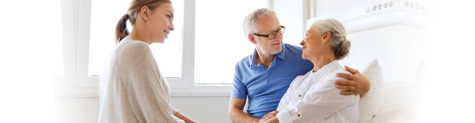 Caregiver interacting with residents in a bright room