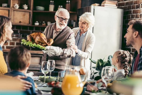 Residents and staff enjoying a Thanksgiving meal together