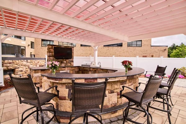Outdoor bar area with seating and landscaping