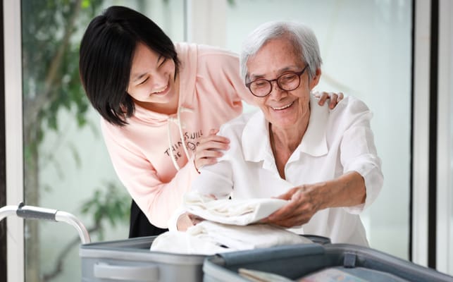 Staff assisting a resident with laundry