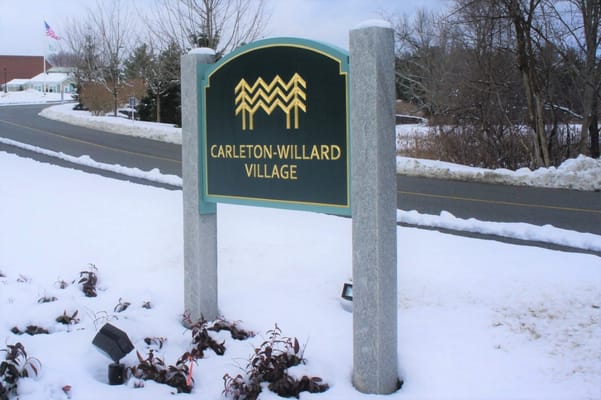 Sign of Carleton-Willard Village surrounded by snow