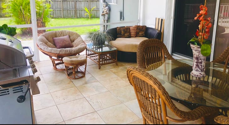 A cozy sunroom area with seating and plants