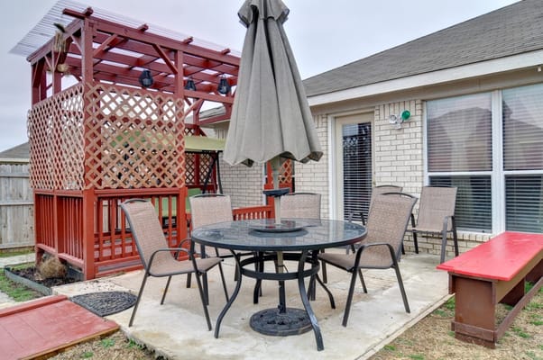 Outdoor patio area with seating and shade