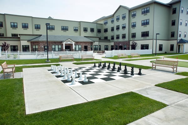 Outdoor chess area with oversized pieces in the garden