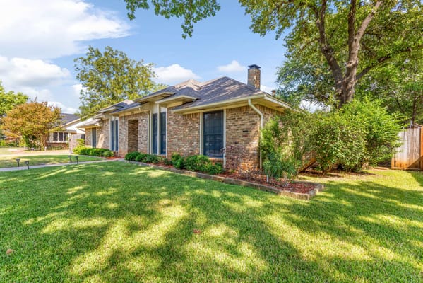 Exterior view of a residential building surrounded by greenery