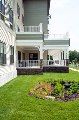 Exterior view of a senior living facility with outdoor space