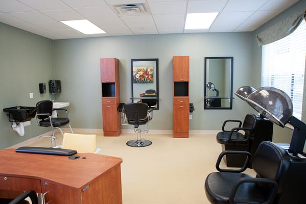 Interior view of a salon with styling chairs and equipment