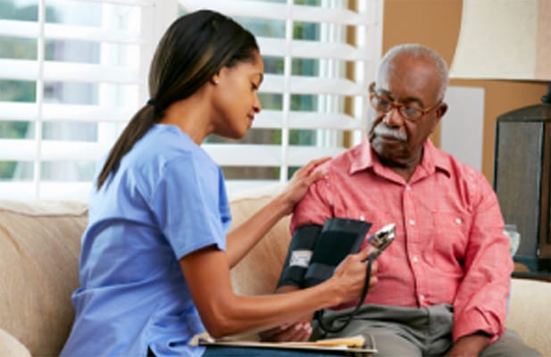 Nurse checking blood pressure of resident