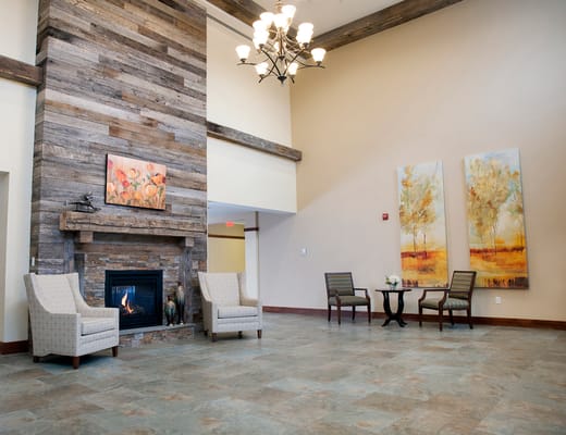 Bright interior common area with seating and fireplace