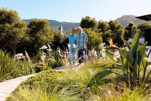 Two residents enjoying a garden stroll