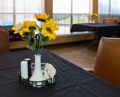 Table setting with sunflowers in a dining area
