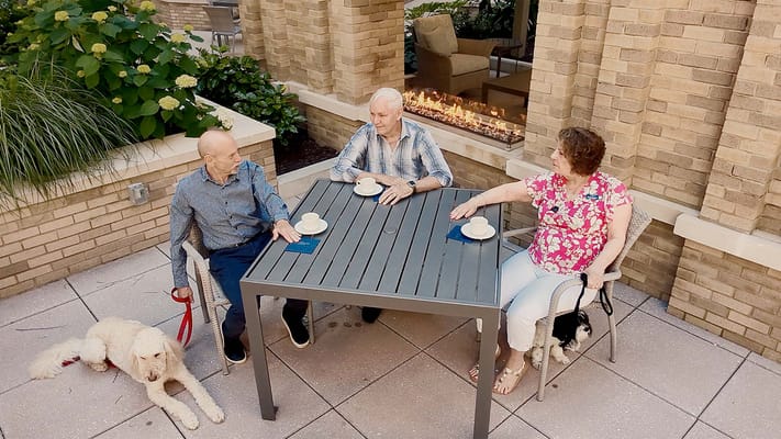 Residents enjoying coffee on an outdoor patio