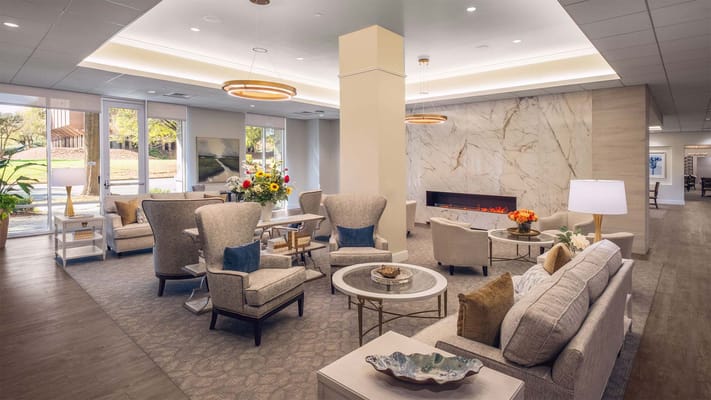 Bright common area with comfortable seating and a fireplace