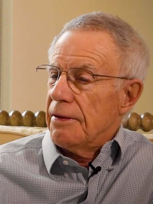 Older man with glasses in a cozy interior setting