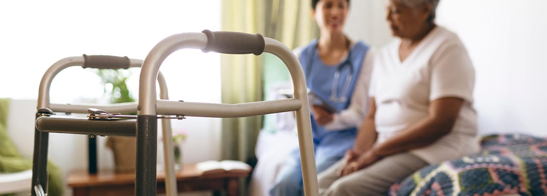 A nurse assisting a resident in a room