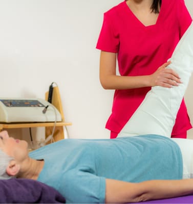 Therapist assisting a resident with leg exercises