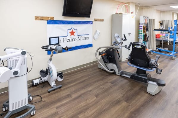 Exercise equipment in the fitness area of San Pedro Manor.