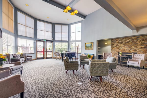 Bright common area with comfortable seating and piano
