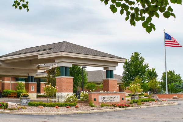 Exterior view of Angela Hospice Care Center with flag