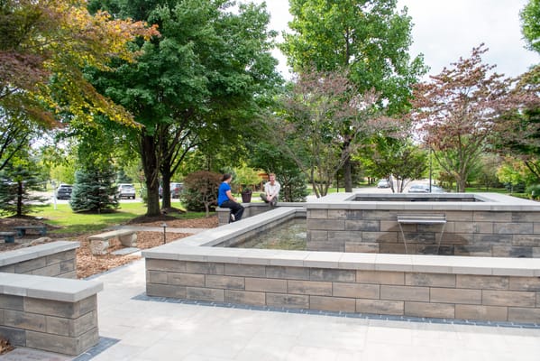 Residents enjoying a tranquil outdoor space with a fountain