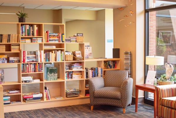 Cozy reading area in a common space with bookshelves