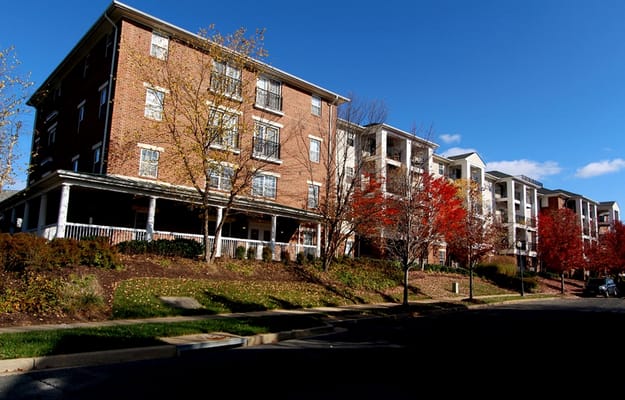 Exterior view of Kentlands Manor Senior Apartments with colorful trees