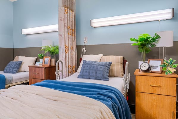 Neatly arranged resident bedroom with cozy decor