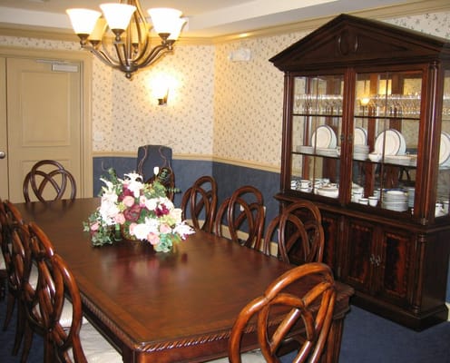 Dining room with wooden table and floral centerpiece