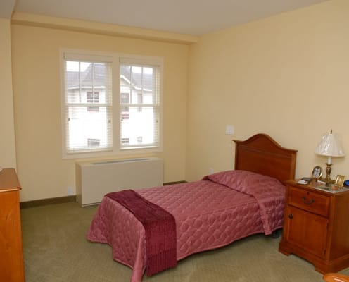 Cozy private resident room with a bed and nightstand