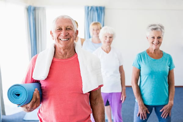 Seniors participating in a yoga class indoors