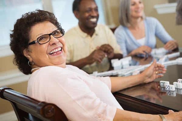 Residents enjoying a game of dominoes in a common area