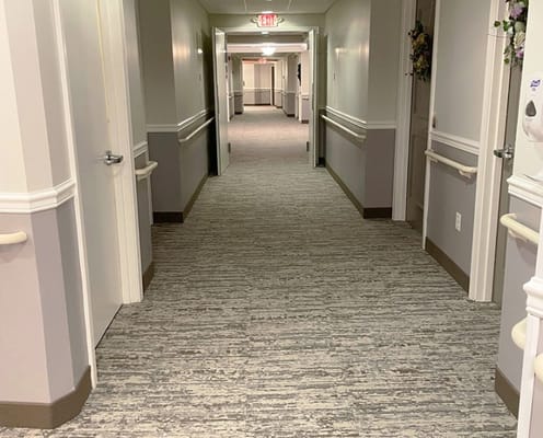 A well-lit hallway in a senior living facility