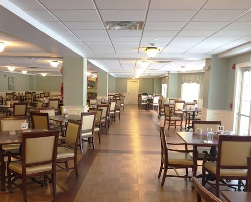Dining room with tables and chairs in a senior living facility