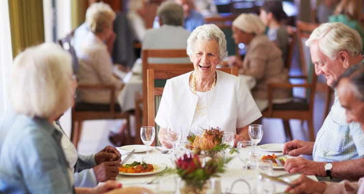 Residents enjoying a meal in the dining room