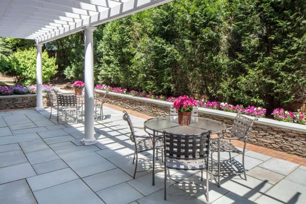Patio area with tables and flowering plants