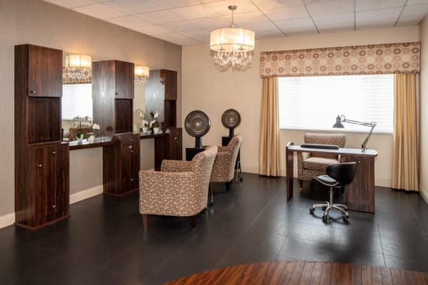 Brightly lit interior space with seating and mirrors