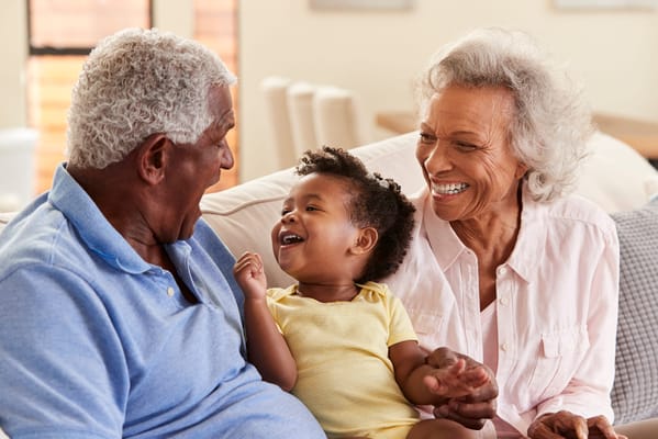 Elderly couple enjoying time with a young child