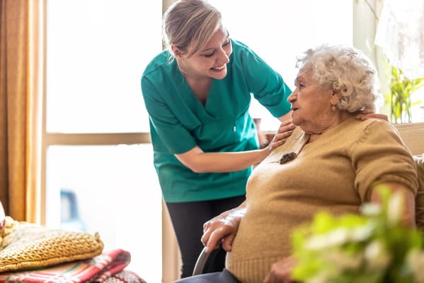 Staff member interacting with a resident in a cozy room